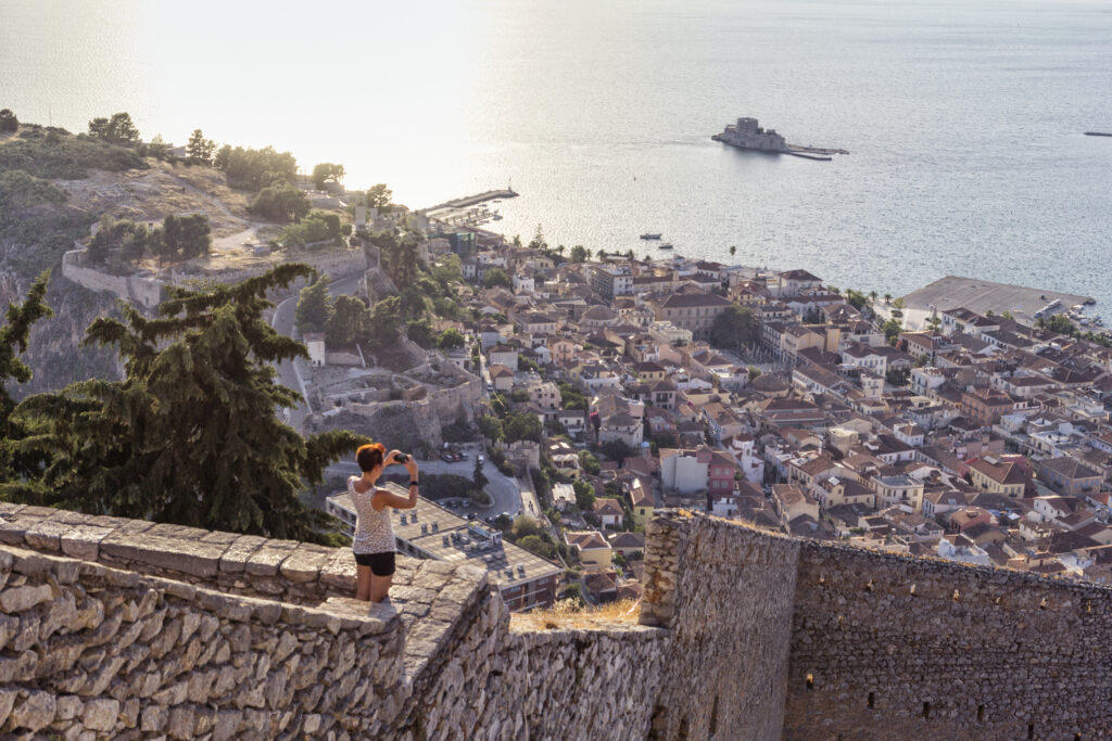 Greece, Peloponnese, Argolis, Nauplia, Argolic Gulf, woman photographing view to Bourtzi Castle