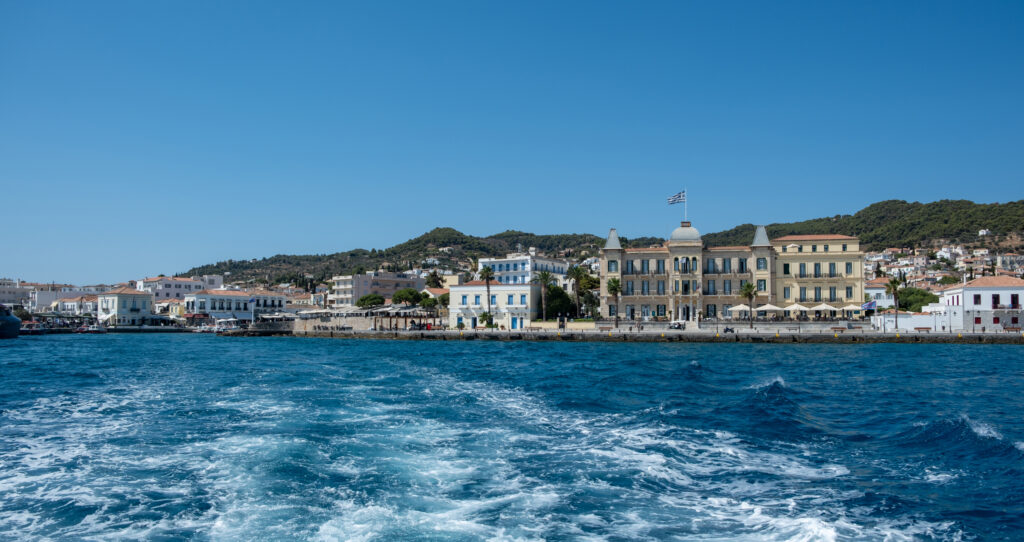 Spetses island, Greece. Seafront buildings and motor boats taxis at small port of Dapia